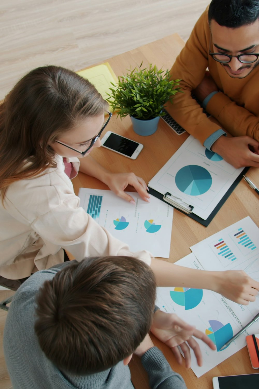 Research team reviewing charts around a table